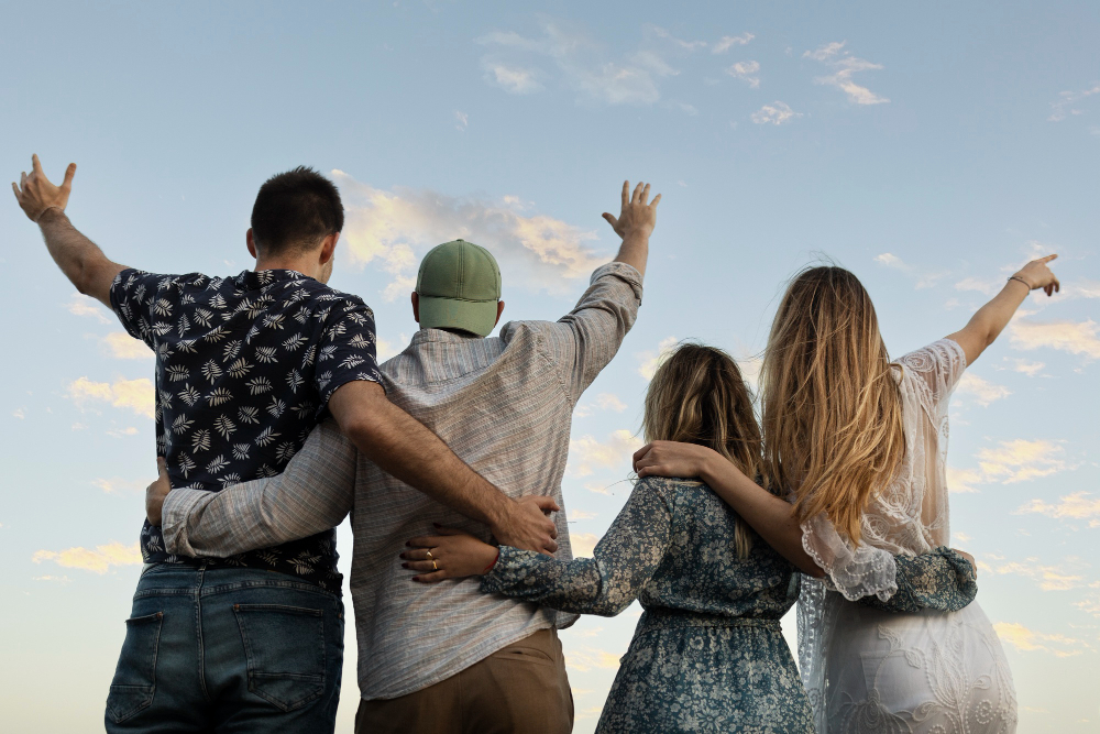 friends embracing with arms up